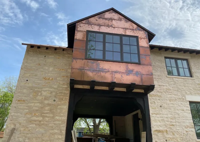 Copper metal panel facade on a stone building for Skylight Installation in Federal Heights