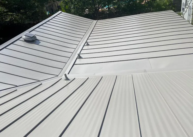 Solar attic fan installed on a metal roof for Roof Ventilation in Federal Heights